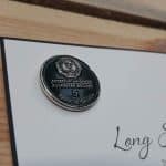 Long service pin badge, card mounted.